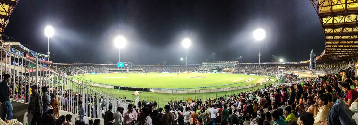 Gaddafi Stadium under lights at night